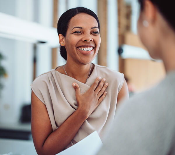 Woman smiling and expressing gratitude during a conversation