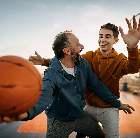 Father playing basketball with his son