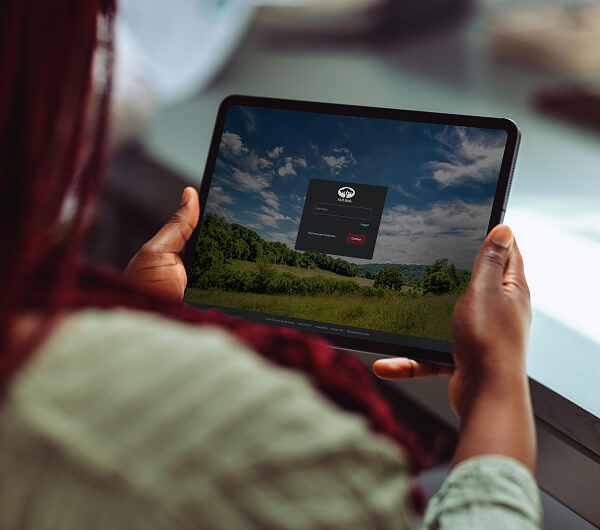 Woman holding tablet with F&M Bank Online Banking Login Screen