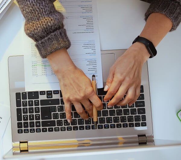 Woman with documents and laptop working