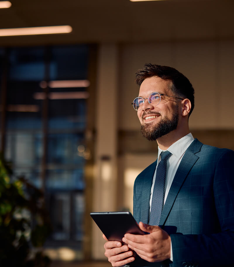 Smiling businessman holding tablet