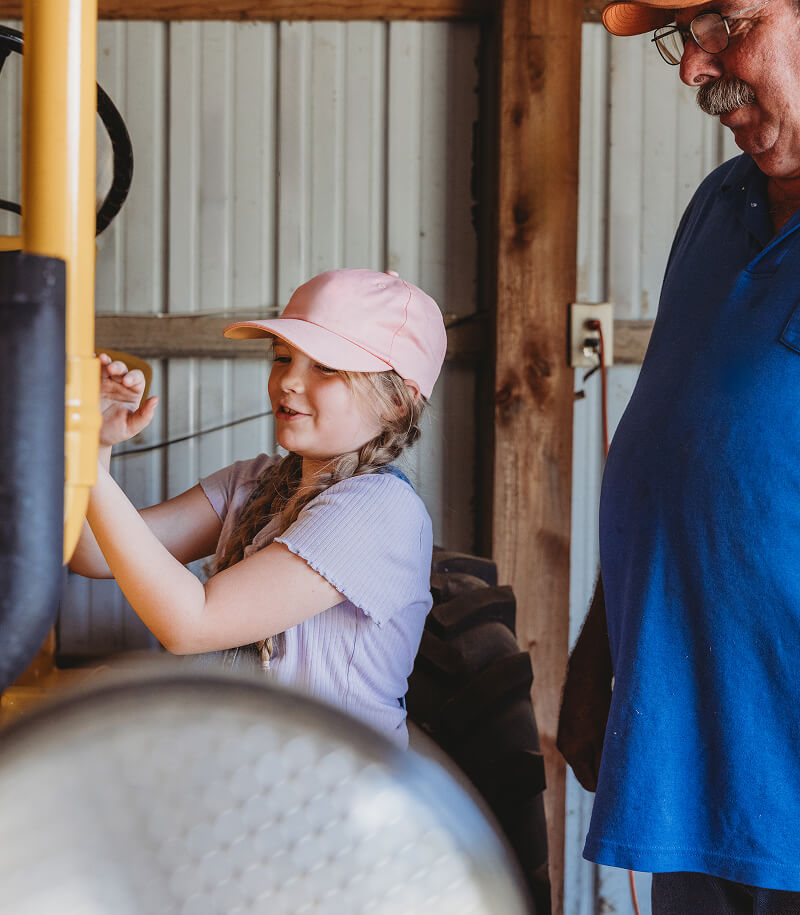 Father and daughter working on equipment.