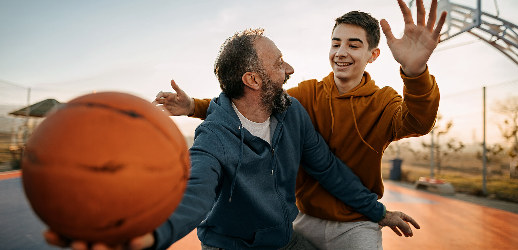 Father playing basketball with his son