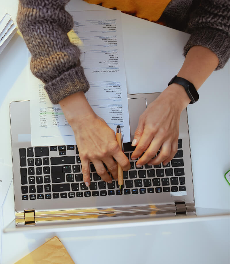 Woman with documents and laptop working
