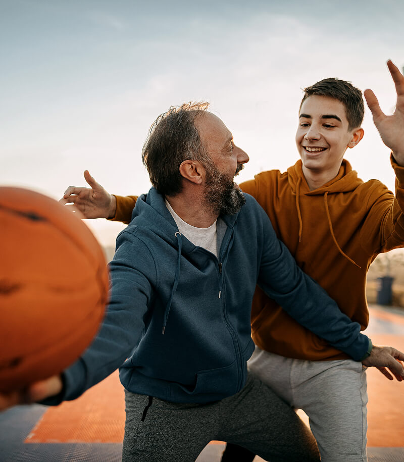 Father playing basketball with his son