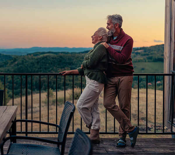 Mature couple with a scenic backdrop.