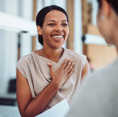 Woman smiling and expressing gratitude during a conversation