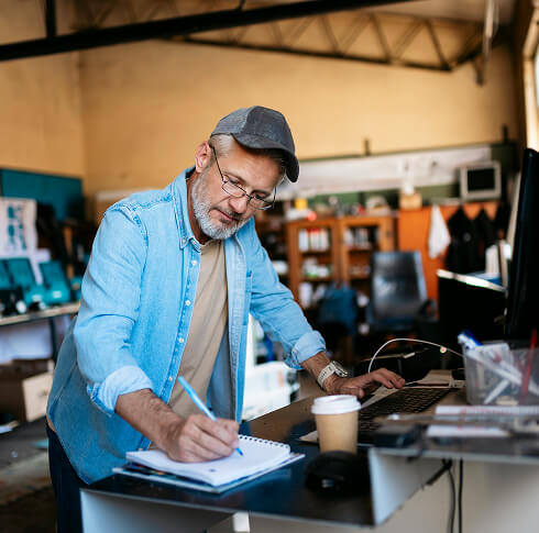 Blue collar man taking notes.