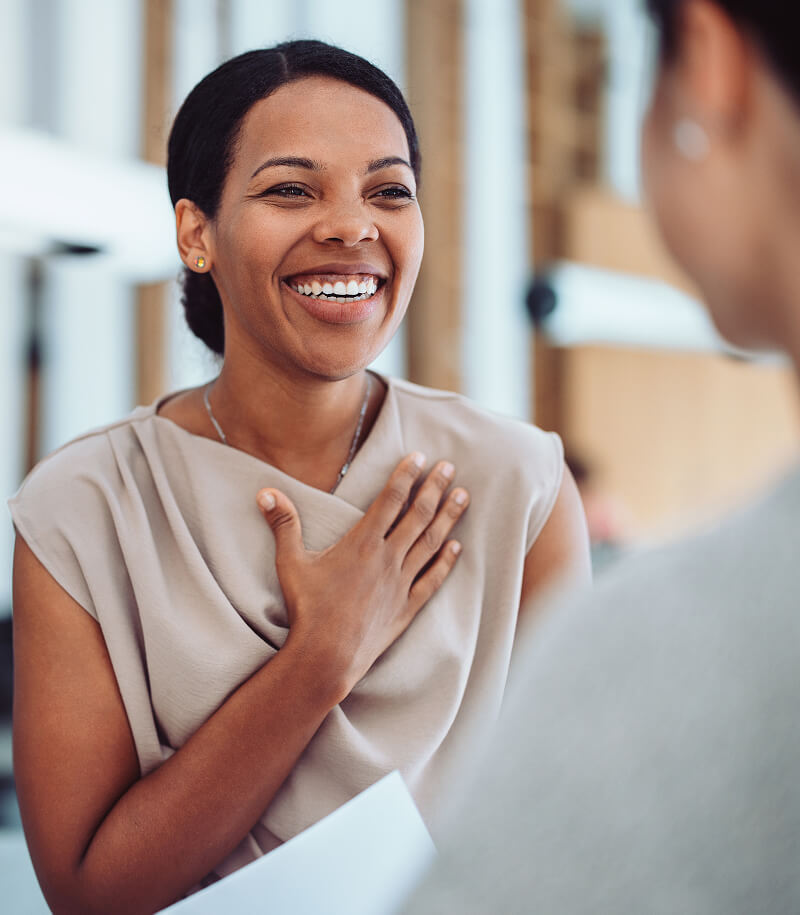 Woman smiling and expressing gratitude during a conversation