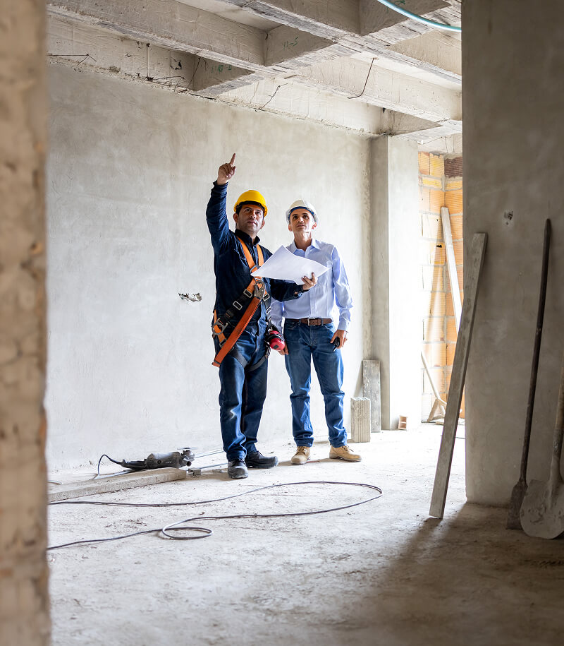 Two construction workers discussing project.