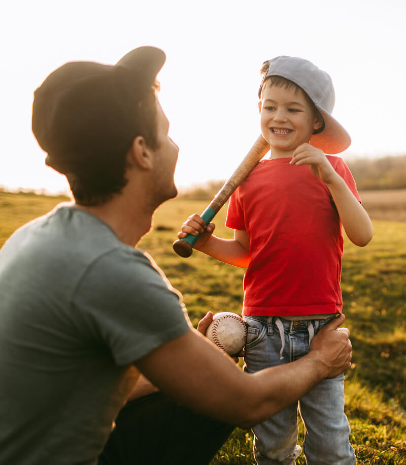 Father and son playing baseball.