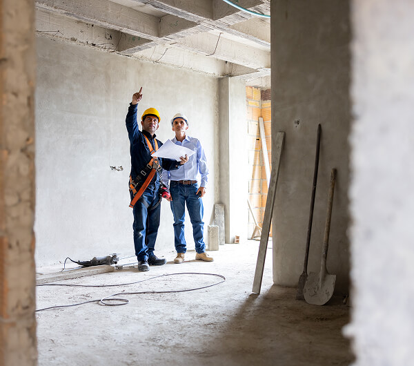 Two construction workers discussing project.