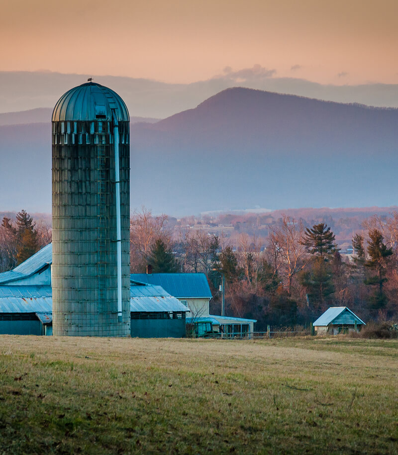 Farm view with mountain range background.