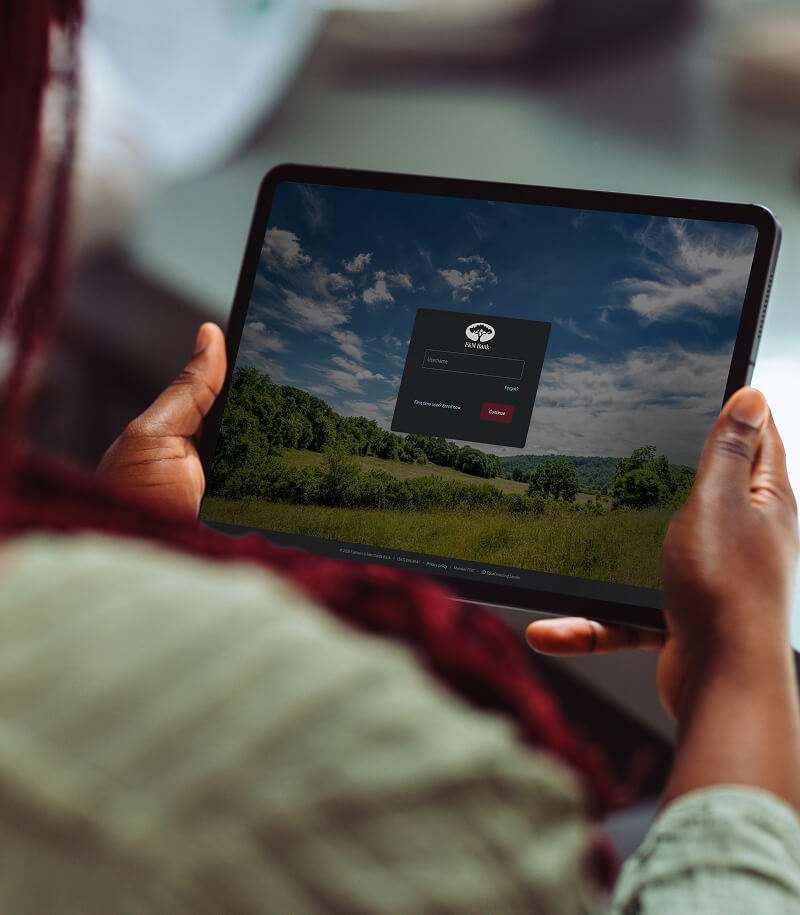 Woman holding tablet with F&M Bank Online Banking Login Screen