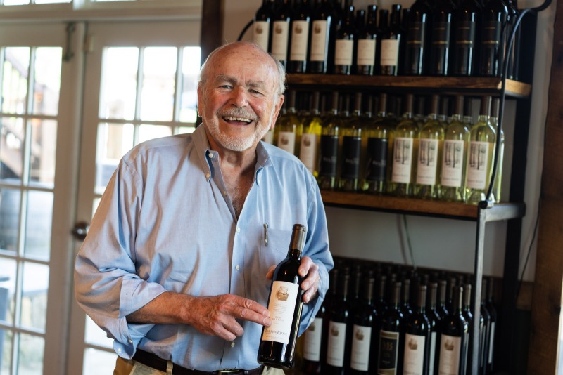 man holding bottle of wine at barren ridge vineyards