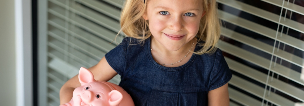 Girl holds piggy bank