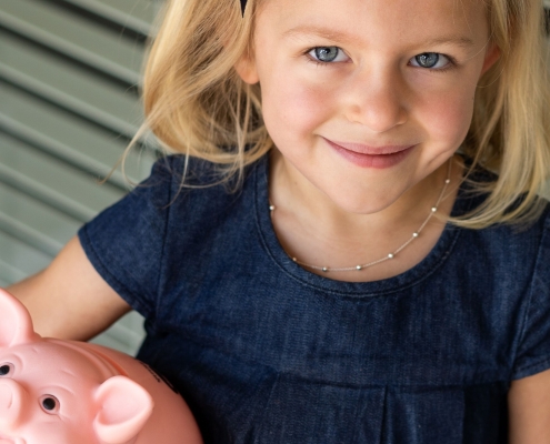 Girl holds piggy bank