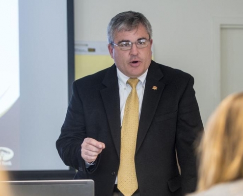 Banker talking with students
