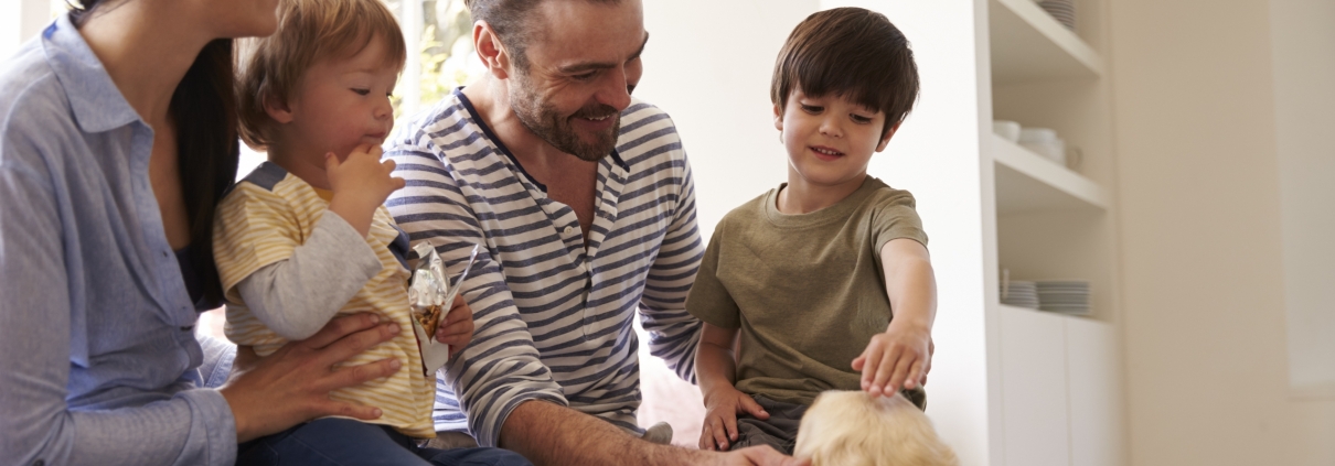 Family Sitting with Dog