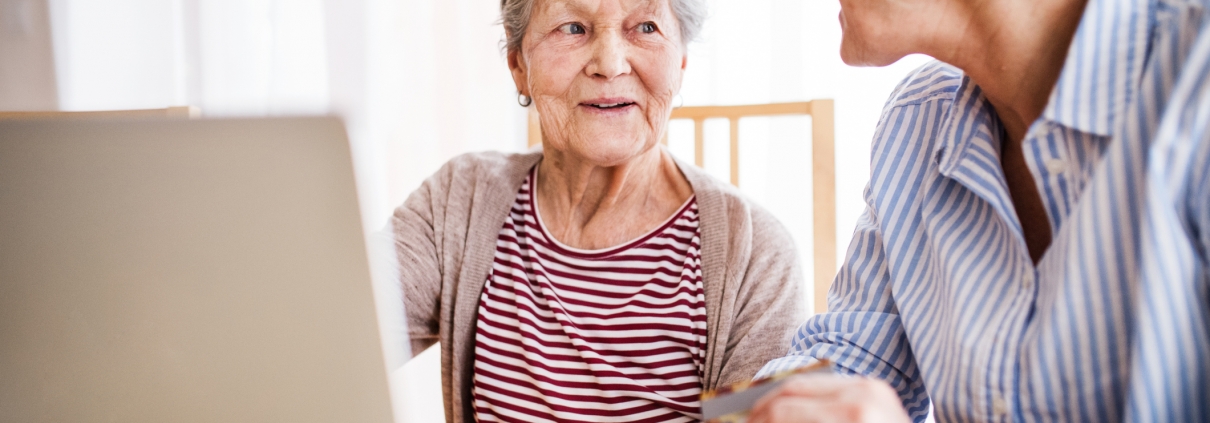 Senior woman with her mother with laptop at home.