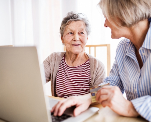 Senior woman with her mother with laptop at home.