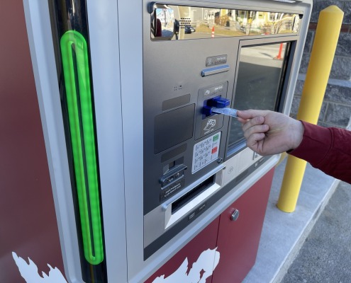 Debit card being inserted into ATM machine