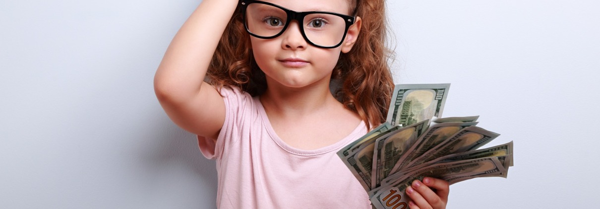 Little girl with money scratching head