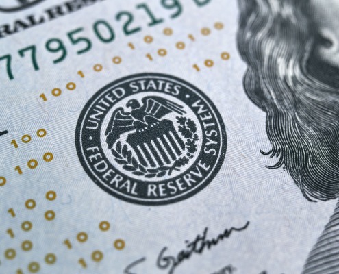 macro photo of federal reserve system symbol on hundred dollar bill.