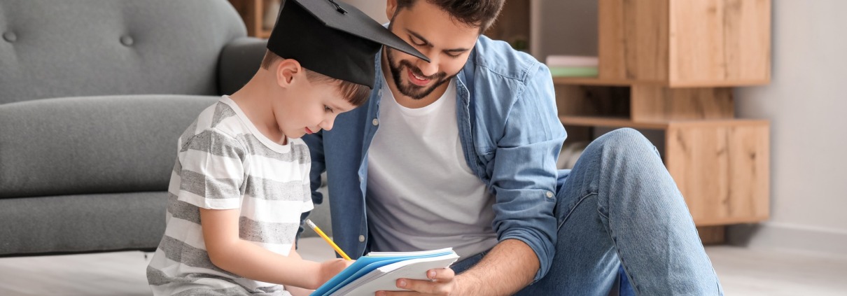 Little boy and father with savings for education at home